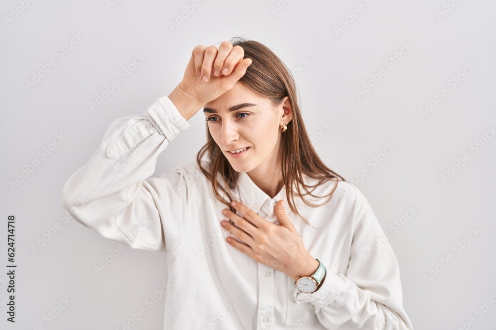 Young caucasian woman standing over isolated background touching forehead for illness and fever, flu and cold, virus sick Young caucasian woman standing over isolated background touching forehead for illness and fever, flu and cold, virus sick