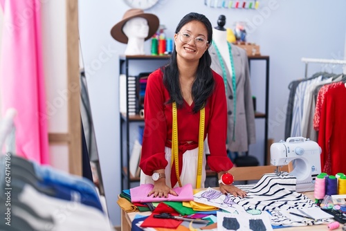 Young chinese woman tailor smiling confident standing at atelier