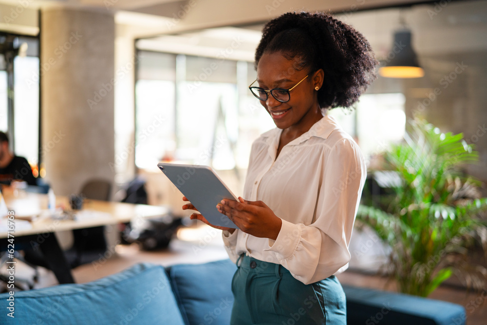 © JustLife - Beautiful African businesswoman using digital tablet in office. Young woman having video call. © JustLife - Beautiful African businesswoman using digital tablet in office. Young woman having video call.