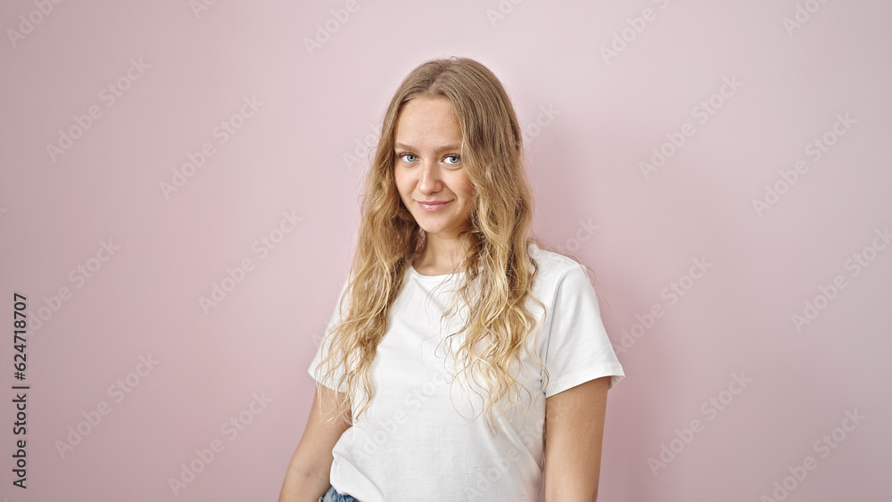 Young blonde woman smiling confident standing over isolated pink background Young blonde woman smiling confident standing over isolated pink background