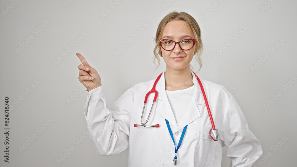 Young blonde woman doctor smiling pointing to the side over isolated white background Young blonde woman doctor smiling pointing to the side over isolated white background