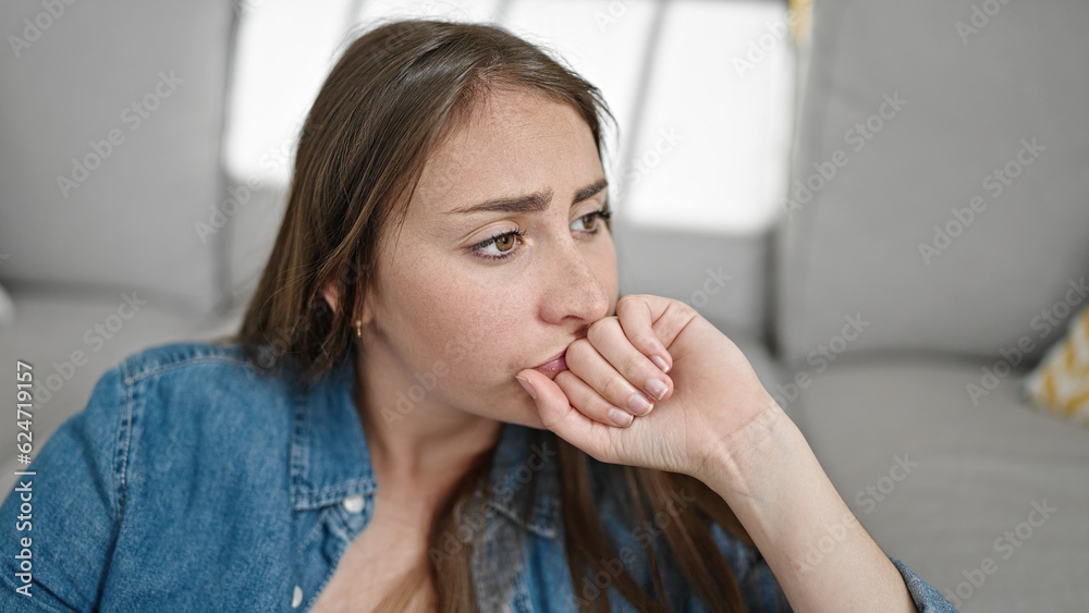 Young beautiful hispanic woman sitting on floor with sad expression at home Young beautiful hispanic woman sitting on floor with sad expression at home