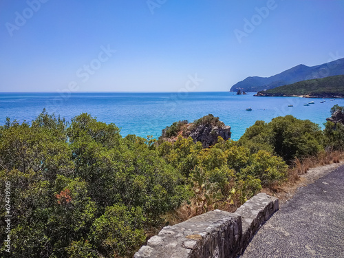 Road and vegetation and mountain of Serra da Arr  bida Natural Park with blue sea  Set  bal PORTUGAL