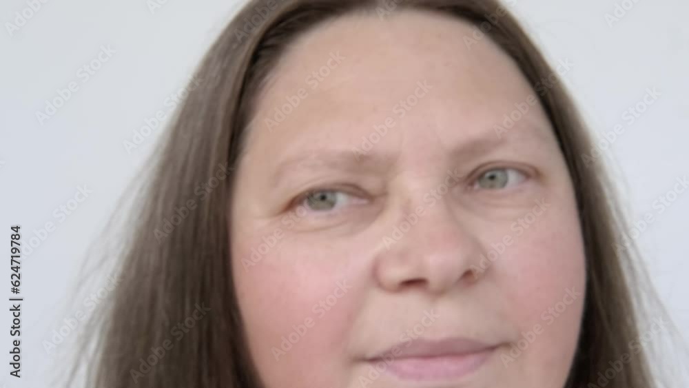 close up mature female face, brown-haired woman 50-55 years old combs with brush long brown with gray hair, age-related changes, self-appreciation, embracing natural beauty close up mature female face, brown-haired woman 50-55 years old combs with brush long brown with gray hair, age-related changes, self-appreciation, embracing natural beauty