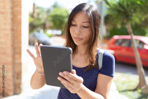 Young asian woman using touchpad at street
