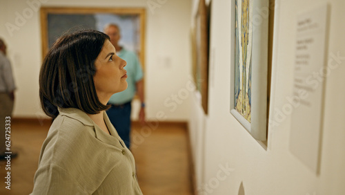 Young beautiful hispanic woman visiting art gallery at Belvedere Palace in Vienna photo
