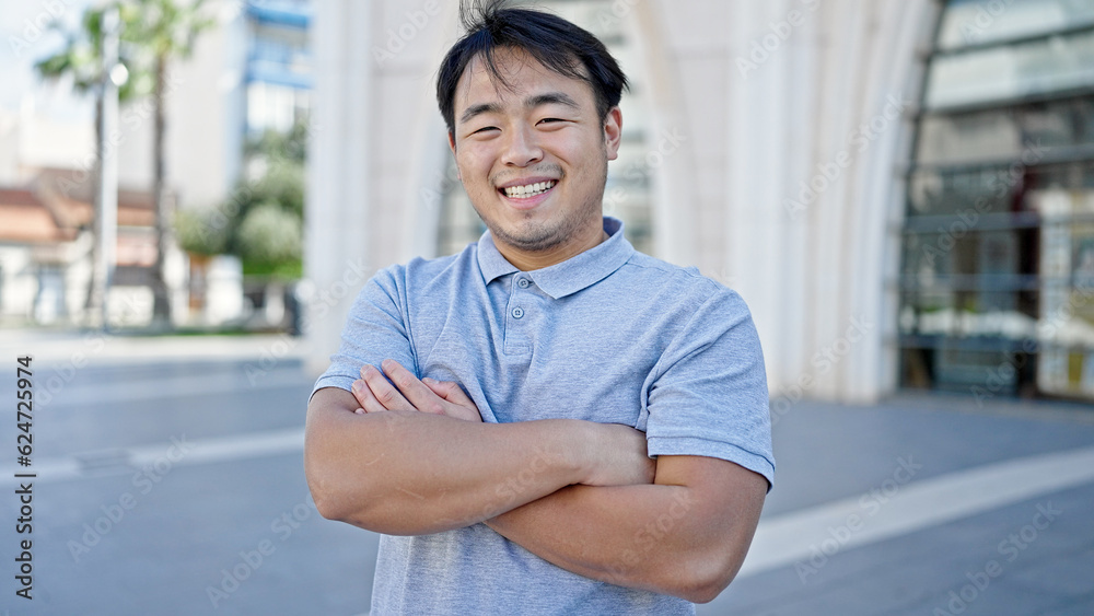  smiling confident standing with arms crossed gesture at street