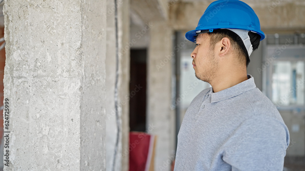 architect standing with serious expression at construction site architect standing with serious expression at construction site
