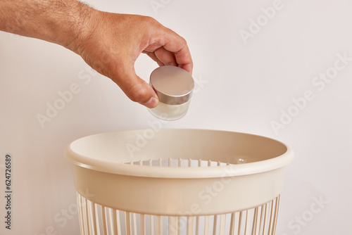 Slika na platnu A jar of hand cream is recycled and thrown into the trash