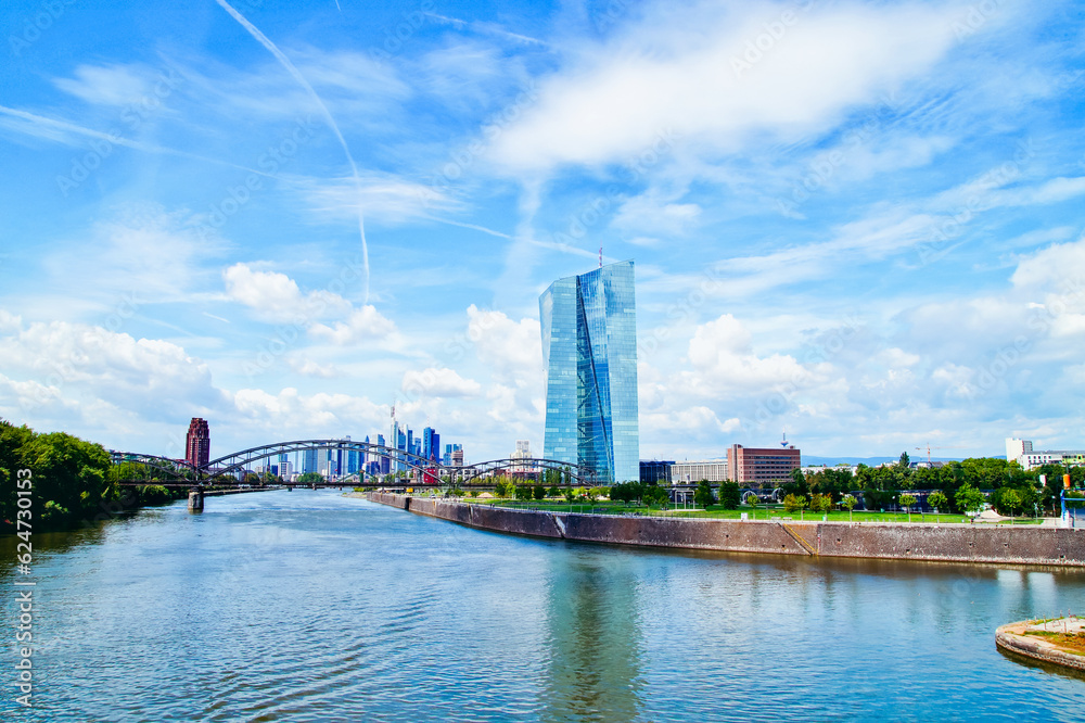 Fototapeta premium view of the river Main and ECB with the european city skyline ,financial centre of Frankfurt. Skyscraper buildings in Germany on blue sky background. Business and finance concept