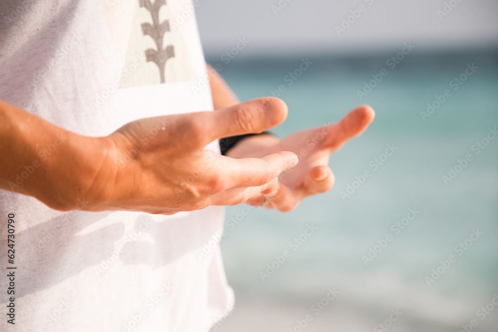 woman doing qigong on beach