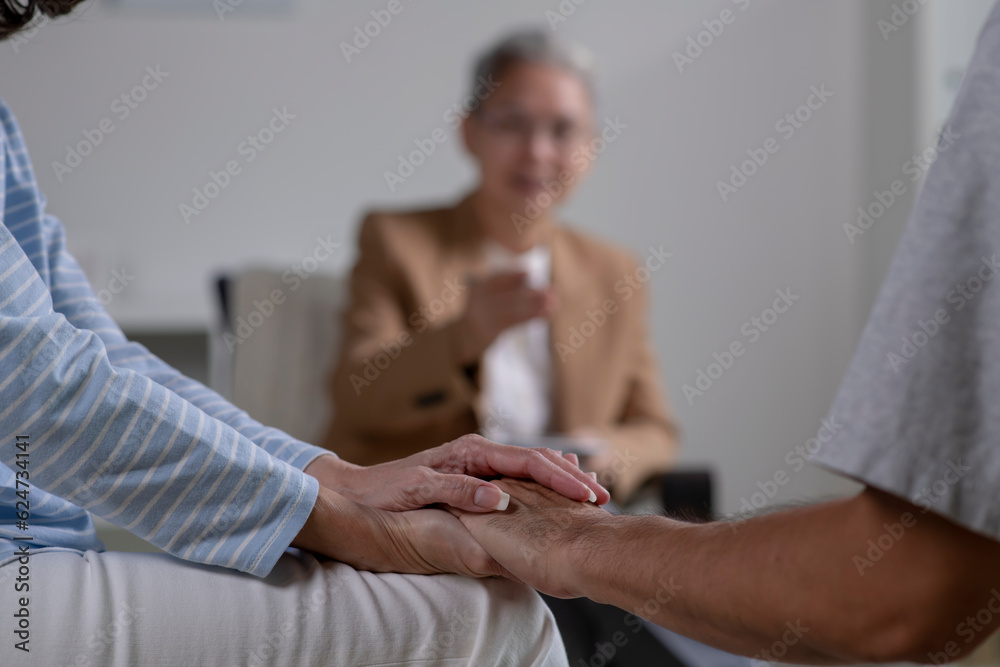 Asian couple consulting couple relationship counselling to solve problems. Asian psychiatrist talking to young couple in office Asian couple consulting couple relationship counselling to solve problems. Asian psychiatrist talking to young couple in office