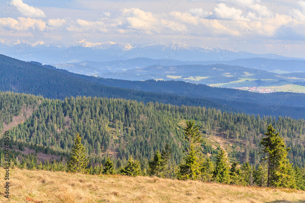 Spring panorama of the Tatra Mountains from the hiking trail near Rysianki in Beskid Żywiecki, Poland