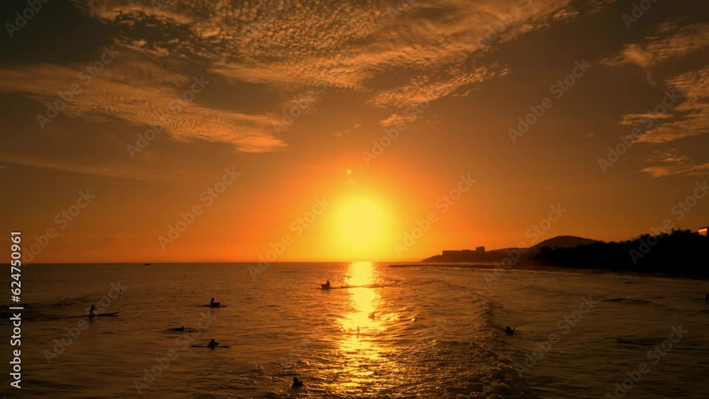 Happy with riding on sea wave on surfboard, people on vacation swimming in the sea,. Surf sea background at sunset. Surfers rides big wave against backdrop beautiful sunset on the sea Vietnam. 4K