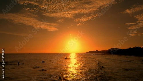 Happy with riding on sea wave on surfboard, people on vacation swimming in the sea,. Surf sea background at sunset. Surfers rides big wave against backdrop beautiful sunset on the sea Vietnam. 4K