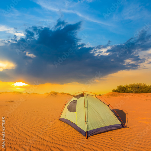 small touristic tent stay among sandy desert at the sunset, summer treavel scene