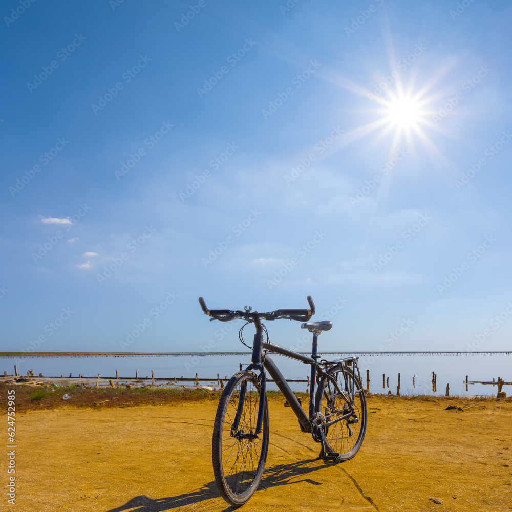 closeup bicycle stay on lake coast at sunny day closeup bicycle stay on lake coast at sunny day