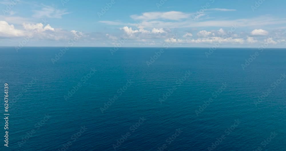 custom made wallpaper toronto digitalFlying over the blue ocean with waves and blue sky with cloud. Mindanao, Philippines.