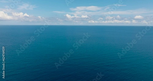Wallpaper Mural Flying over the blue ocean with waves and blue sky with cloud. Mindanao, Philippines. Torontodigital.ca