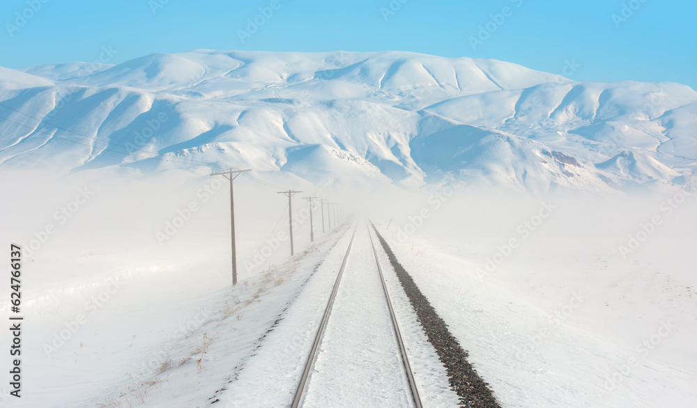 Snowy winter railroad view - Railroad track with mountain range