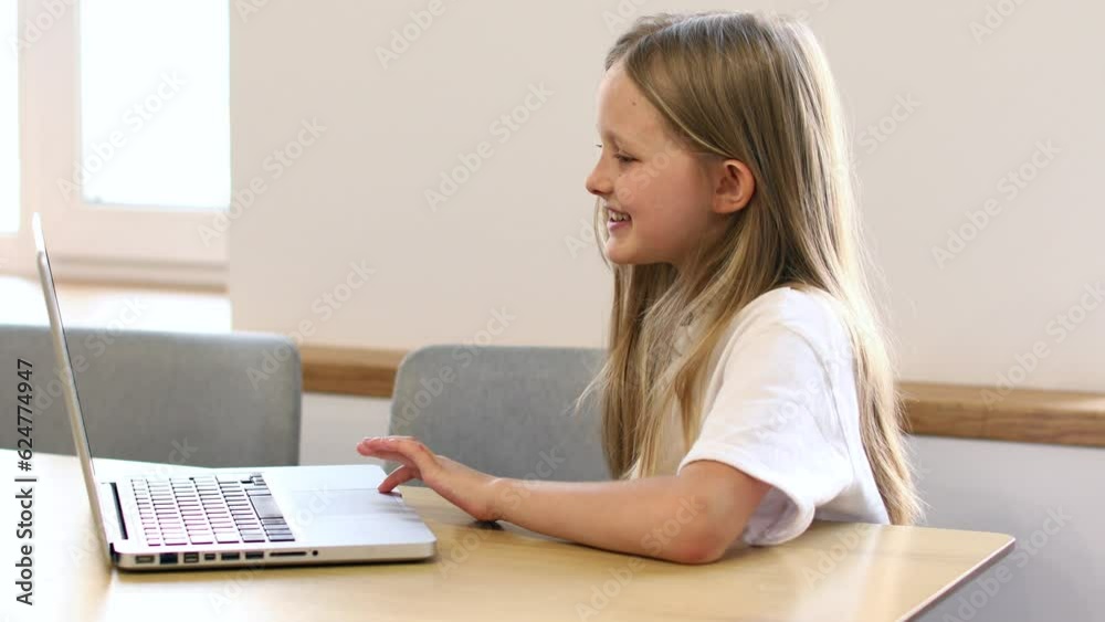 Smiling girl having video call in remote class with teacher using laptop, happy little kid greeting with tutor, learning online on computer, home learning concept, video 4k Smiling girl having video call in remote class with teacher using laptop, happy little kid greeting with tutor, learning online on computer, home learning concept, video 4k