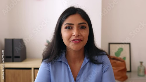 POV screen view of young indian businesswoman talking with colleague on laptop video call. Head shot of confident professional ethnic female having an online conversation. 