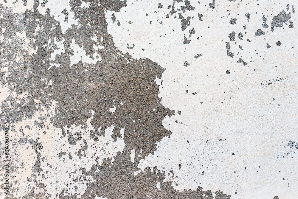 Fototapeta premium Peeled white paint on an old rough concrete wall. Abstract textured background.