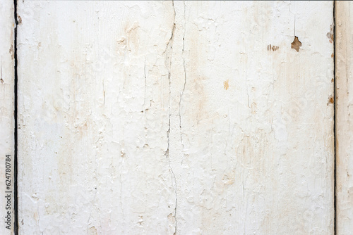 Close up photo of a wooden plank covered with white old cracked paint. Abstract background