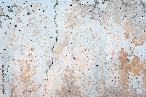 Cracked old grey dirty plastered wall abstract background