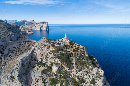 Lighthouse of Formentor, on the island of Mallorca. Aerial view of the cliffs in the mountains of the Serra de Tramuntana, with the road leading to the lighthouse. Balearic Islands, Spain.