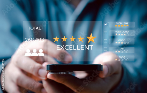 Businessman using smartphone to give golden five stars for client the best satisfaction evaluation survey after use product and service concept.