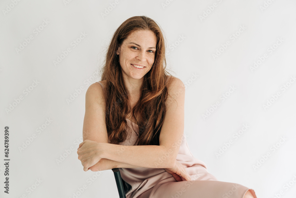 Portrait of a young smiling redhead woman on a white background. Portrait of a young smiling redhead woman on a white background.