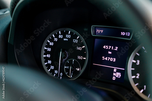 Close-up of the odometer and dashboard of a luxury car with a black interior after detailing and washing at a car service