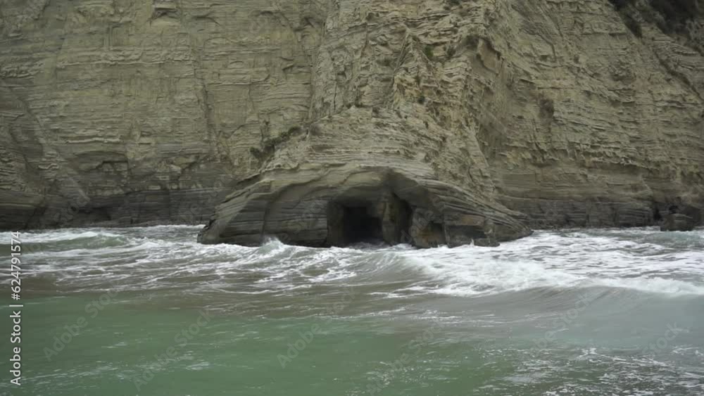 Cloudy day and big waves in Tolaga Bay, New Zealand. 