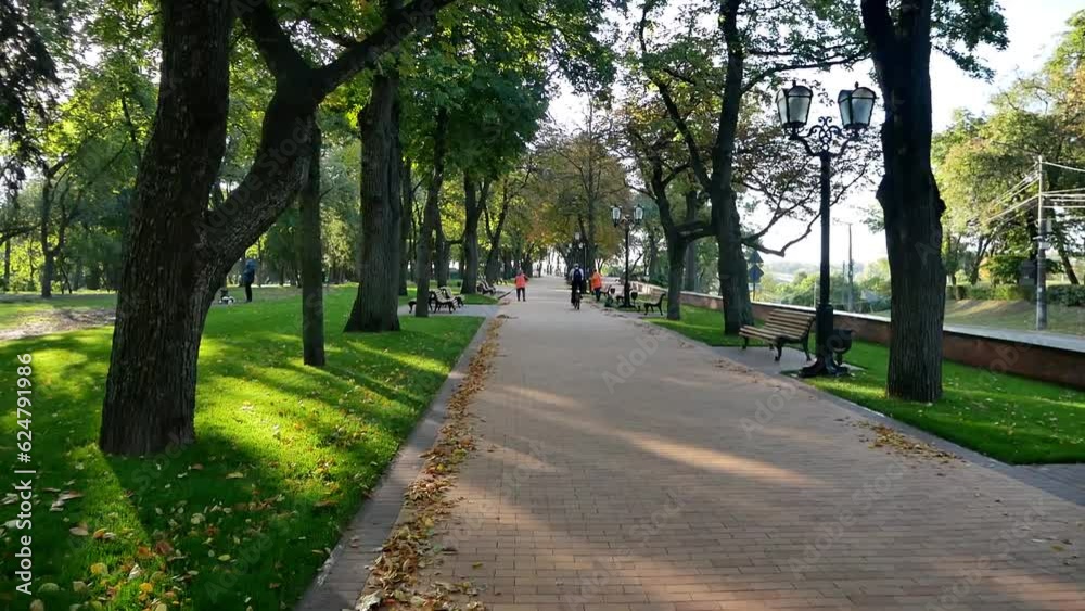 morning landscape in the city park
sunny autumn morning
in the distance, janitors sweep up fallen leaves and a man rides by on a bicycle
concept of improvement of urban space morning landscape in the city park
sunny autumn morning
in the distance, janitors sweep up fallen leaves and a man rides by on a bicycle
concept of improvement of urban space