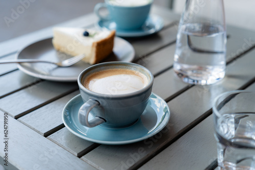 Cup of coffee and cheesecake on breakfast table