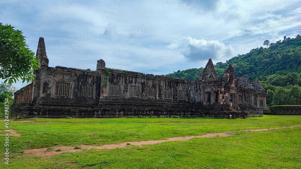 The beautiful of sanctuary and the green natural walkway side of  of Wat Phouvat Phou Hindu vat Phou Temple complex is the UNESCO world heritage site in Champasak,  Laos at the blue cloud sky day.