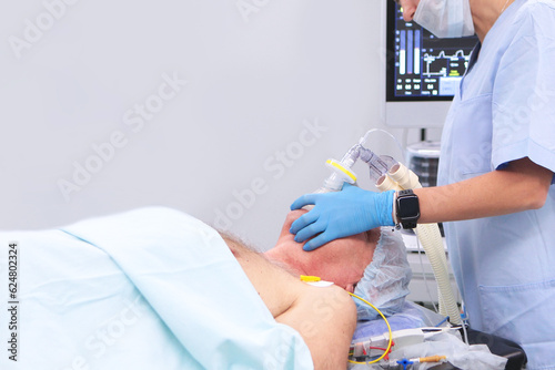 An elderly man is undergoing surgery.Preparation for anesthesia and surgical intervention of an elderly man. Modern medicine.