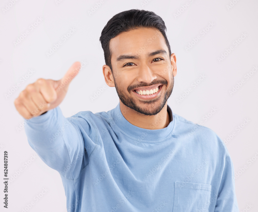 Portrait, smile and asian man in studio with thumbs up, hand or thank you sign on grey background. Happy, face and Japanese male with finger emoji for yes, vote or positive review, success or agree Portrait, smile and asian man in studio with thumbs up, hand or thank you sign on grey background. Happy, face and Japanese male with finger emoji for yes, vote or positive review, success or agree