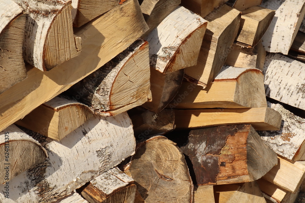 Brown birch firewood with a structure for a fireplace stove, a bath fire, a sauna on a clear day Brown birch firewood with a structure for a fireplace stove, a bath fire, a sauna on a clear day