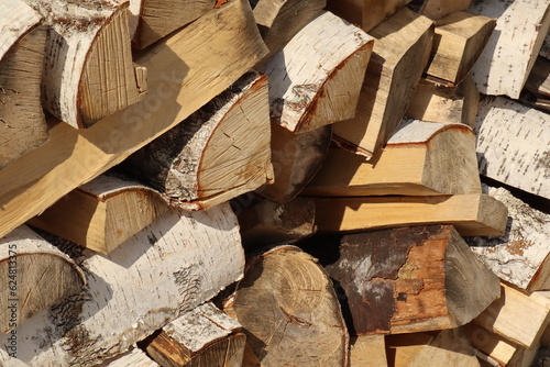 Brown birch firewood with a structure for a fireplace stove, a bath fire, a sauna on a clear day