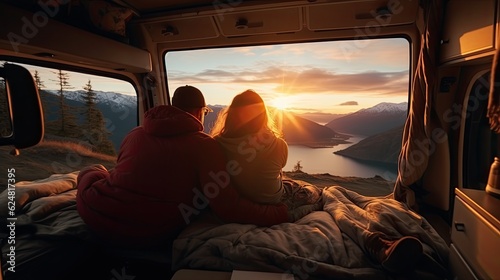 Young copuple of lovers enjoying the views in a camper van.