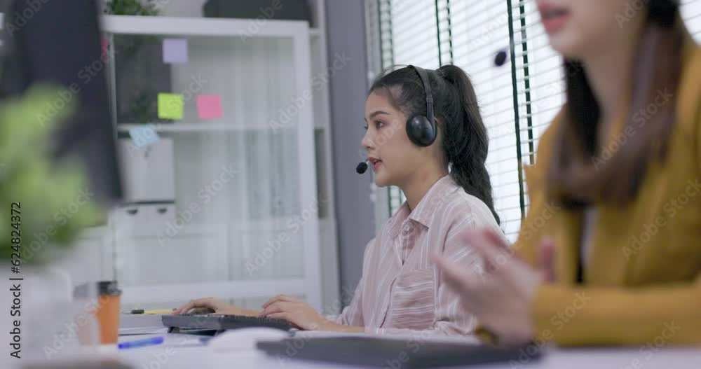 two female call center worker is consulting with a customer who calls in for information over the phone in the office. Businessman wearing headphones to talk to customers. communication technology two female call center worker is consulting with a customer who calls in for information over the phone in the office. Businessman wearing headphones to talk to customers. communication technology