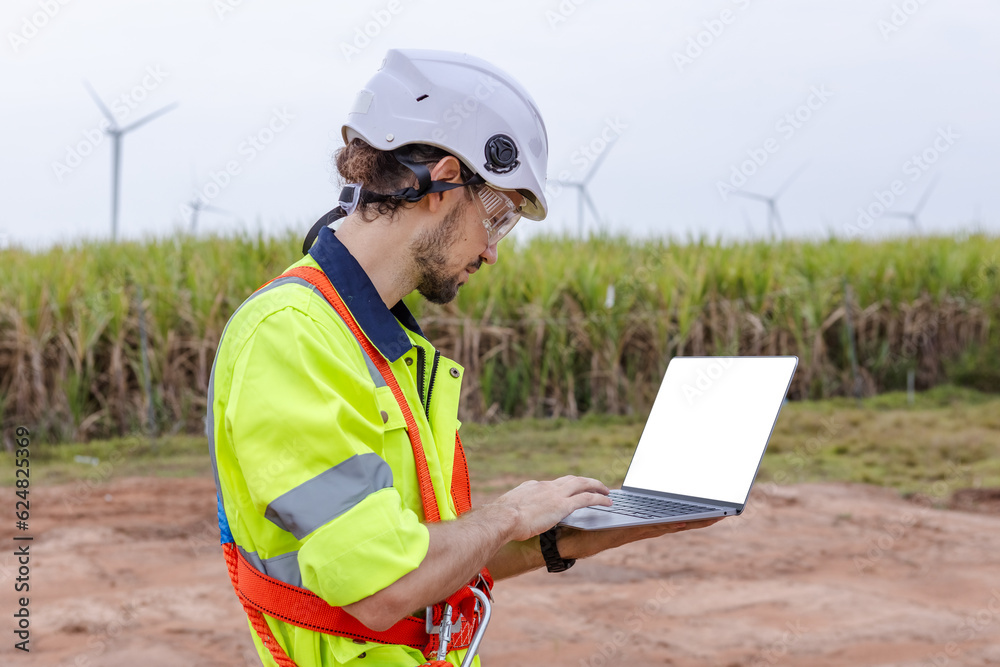 Man engineer of wind turbine worker using laptop white screen working about renewable energy at wind farm. energy power wind. technology protect environment reduce global warming problems. Man engineer of wind turbine worker using laptop white screen working about renewable energy at wind farm. energy power wind. technology protect environment reduce global warming problems.