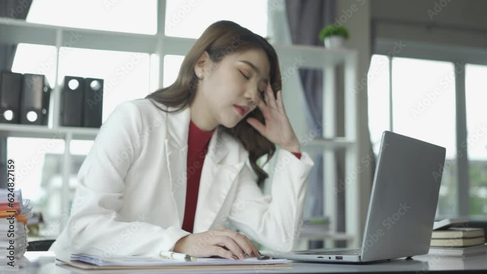 business woman in the office who is serious about work Stressed and worried about not completing tasks on time. Woman who owns the company. She had a headache due to paperwork piled up on her desk. business woman in the office who is serious about work Stressed and worried about not completing tasks on time. Woman who owns the company. She had a headache due to paperwork piled up on her desk.