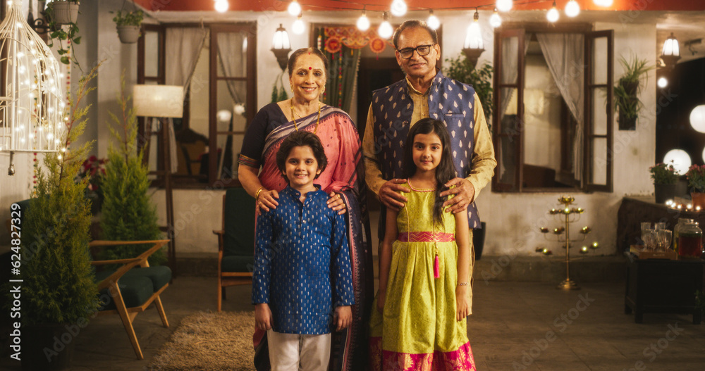 Portrait of Indian Family in Traditional Clothes Posing Together in Authentic Mumbai House. Senior Grandparents and Their Cute Grandkids Looking at the Camera, Happily Taking a Family Photo