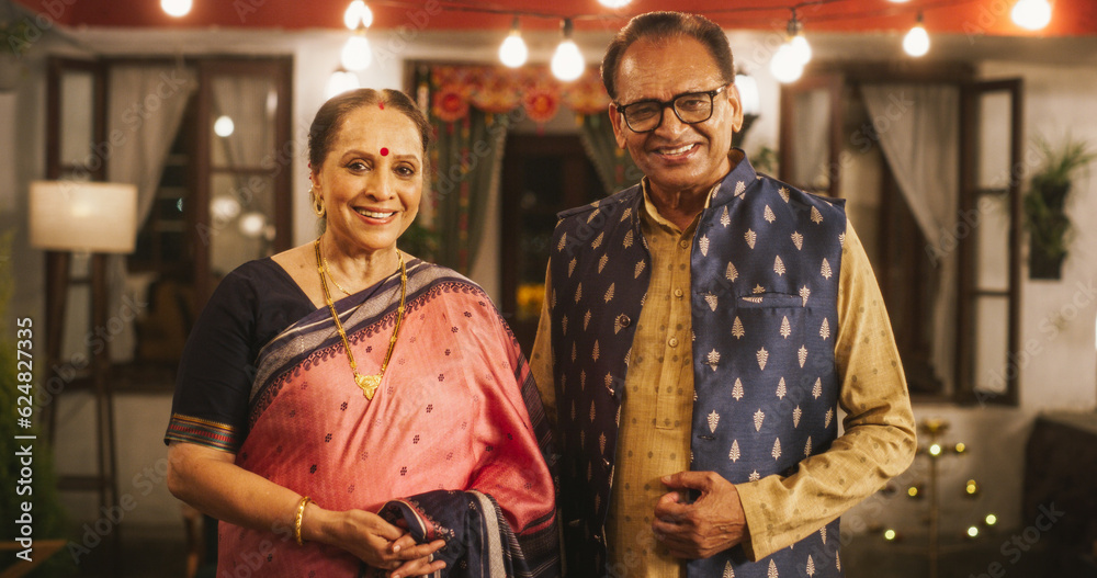 Portrait of Happy Indian Elderly Couple in Traditional Clothes Posing Together at Their Authentic Mumbai Home. Senior Husband and Wife Celebrating Diwali, Looking at the Camera
