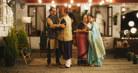 Authentic Shot of Indian Elderly Couple Receiving Family Relatives Over. Genuine Happiness in a Reunion Between Friends to Celebrate Diwali Together. Greetings, Appreciation and Gifts are Shared