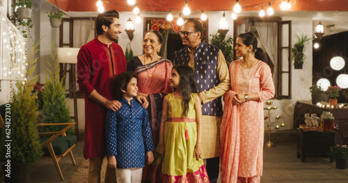 Portrait of Happy Indian Family in Traditional Clothes Laughing and Posing Together in Authentic Mumbai House. Gorgeous Parents, Grandparents, and Cute Kids Looking at the Camera