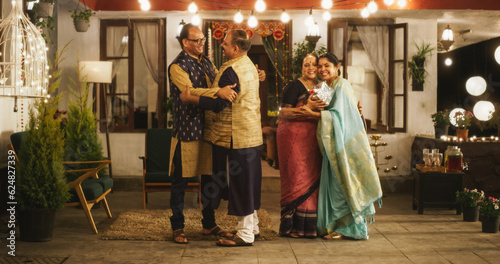 Authentic Shot of Indian Elderly Couple Receiving Family Relatives Over. Genuine Happiness in a Reunion Between Friends to Celebrate Diwali Together. Greetings, Appreciation and Gifts are Shared photo